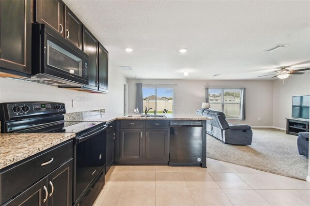 8034 Broad Pointe Dr, Zephyrhills, FL 33540 - kitchen featuring black appliances, open floor plan, a peninsula, light carpet, and a ceiling fan