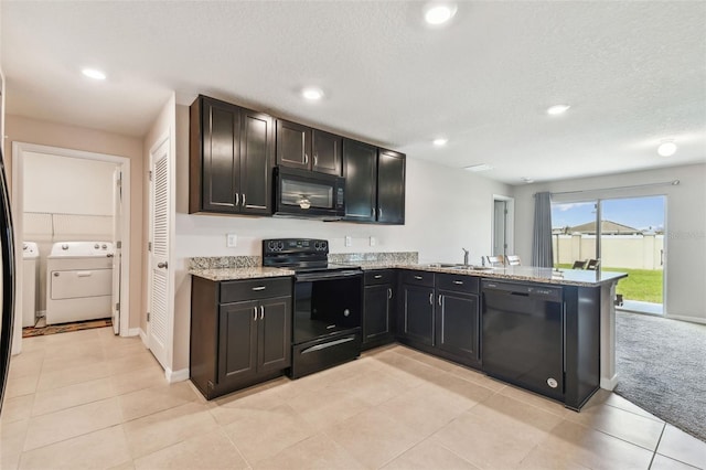 8034 Broad Pointe Dr, Zephyrhills, FL 33540 - kitchen with black appliances, washing machine and clothes dryer, recessed lighting, a peninsula, and light stone counters