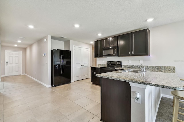 8034 Broad Pointe Dr, Zephyrhills, FL 33540 - kitchen featuring black appliances, a peninsula, a breakfast bar, recessed lighting, and light tile patterned floors