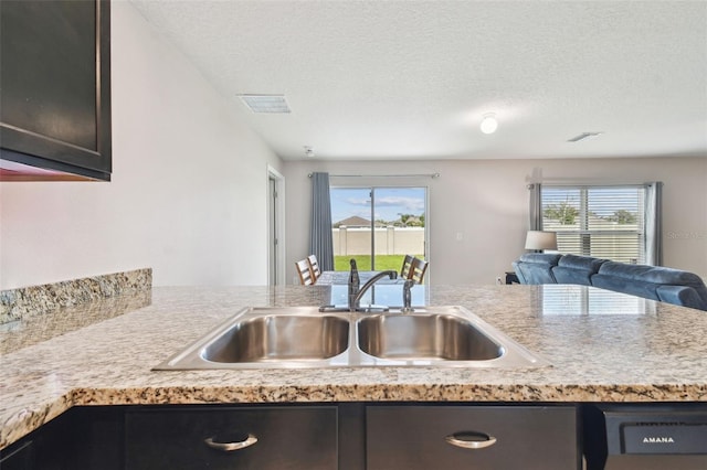 8034 Broad Pointe Dr, Zephyrhills, FL 33540 - kitchen featuring open floor plan, light countertops, healthy amount of natural light, and a textured ceiling