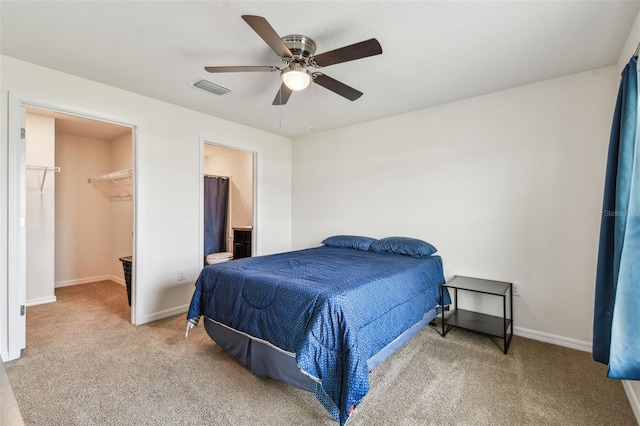 8034 Broad Pointe Dr, Zephyrhills, FL 33540 - bedroom featuring carpet flooring, a spacious closet, a ceiling fan, and ensuite bath