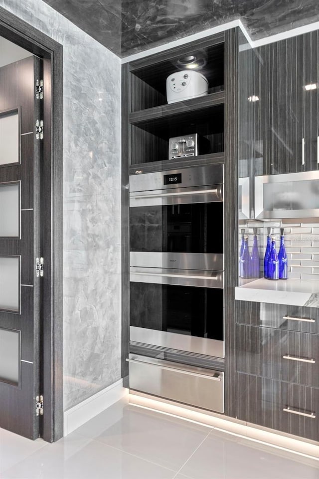 interior details with stainless steel double oven and a warming drawer