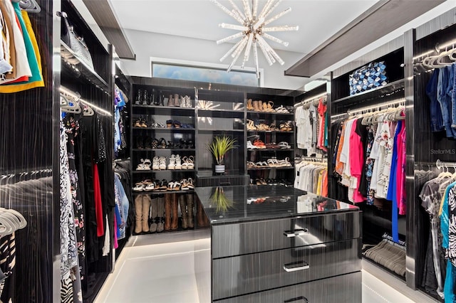 walk in closet with an inviting chandelier