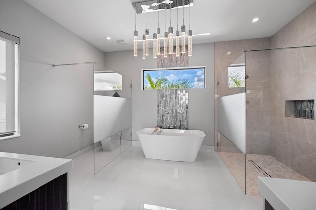 bathroom featuring visible vents, a freestanding bath, vanity, a walk in shower, and recessed lighting