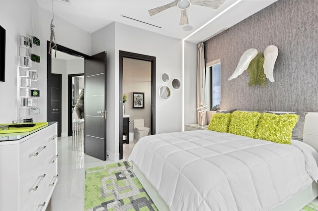 bedroom featuring an accent wall and a ceiling fan