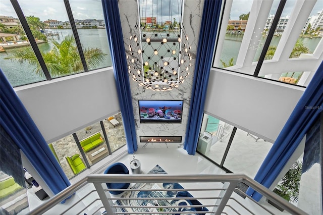 stairs with a water view and a fireplace