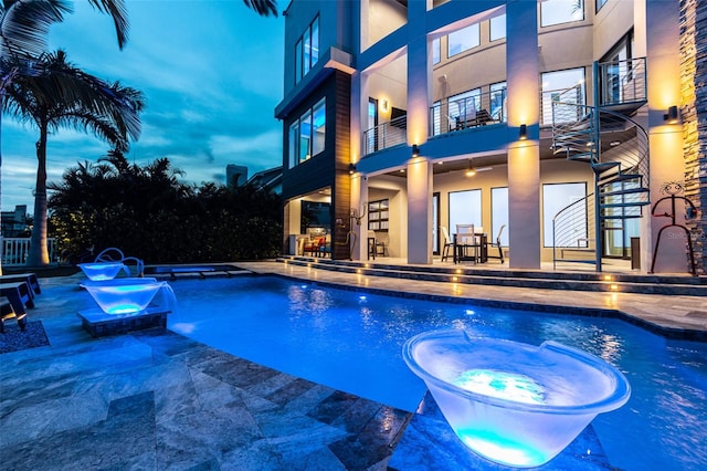 view of pool with stairs, a patio area, and a pool with connected hot tub