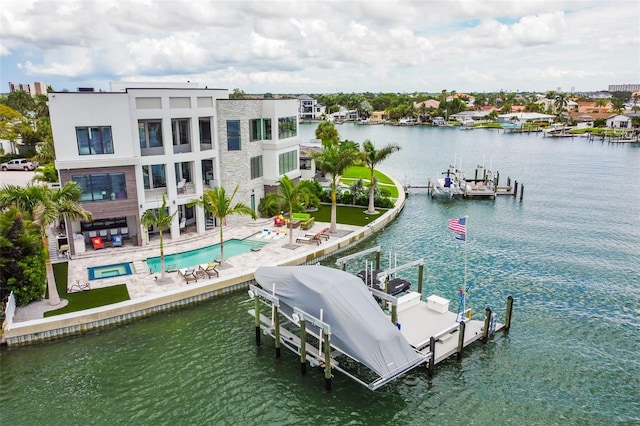 view of dock with a patio area, a water view, boat lift, and a community pool