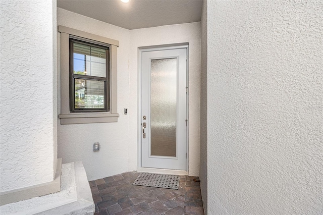 view of exterior entry featuring stucco siding