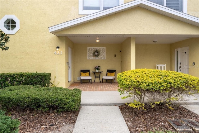 doorway to property featuring stucco siding