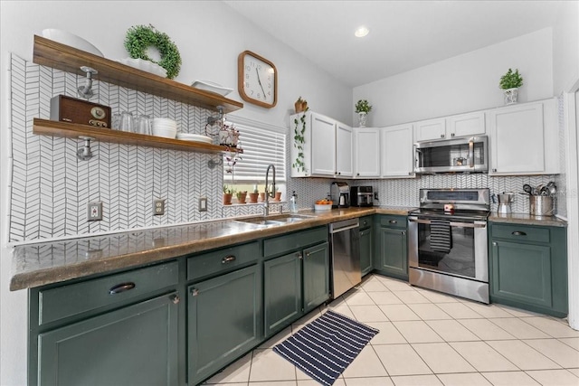 kitchen with open shelves, decorative backsplash, appliances with stainless steel finishes, white cabinetry, and a sink