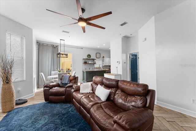 living area with a ceiling fan, recessed lighting, visible vents, and baseboards