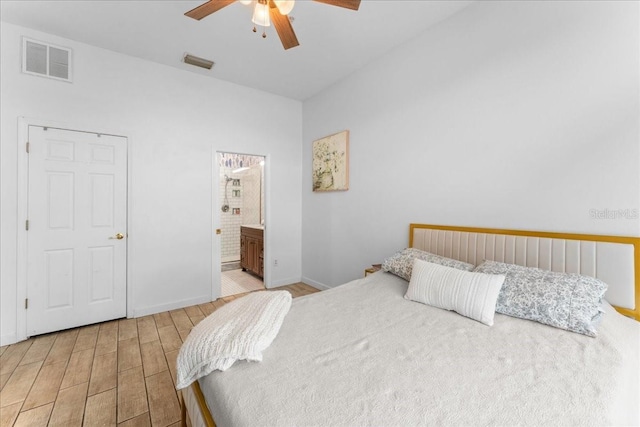 bedroom with a ceiling fan, visible vents, baseboards, and wood finished floors