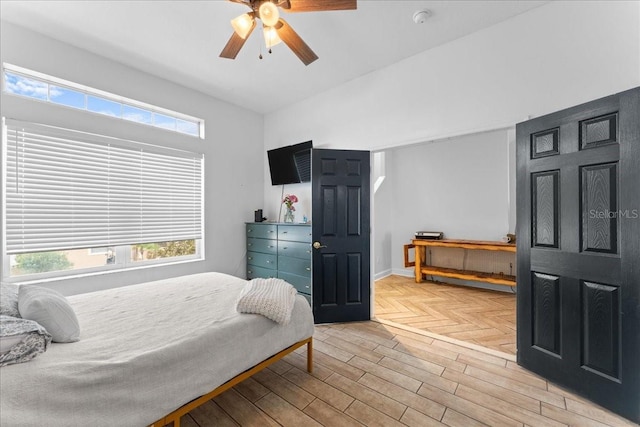 bedroom with ceiling fan and parquet floors