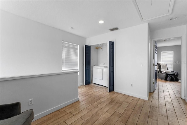 interior space featuring washer / clothes dryer, visible vents, light wood-style flooring, and baseboards