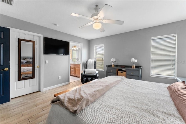 bedroom with ceiling fan, visible vents, baseboards, light wood-style floors, and ensuite bath