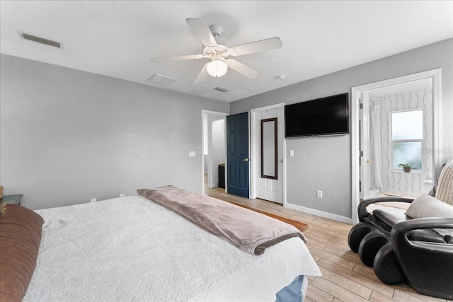 bedroom with light wood-style floors, baseboards, visible vents, and a ceiling fan