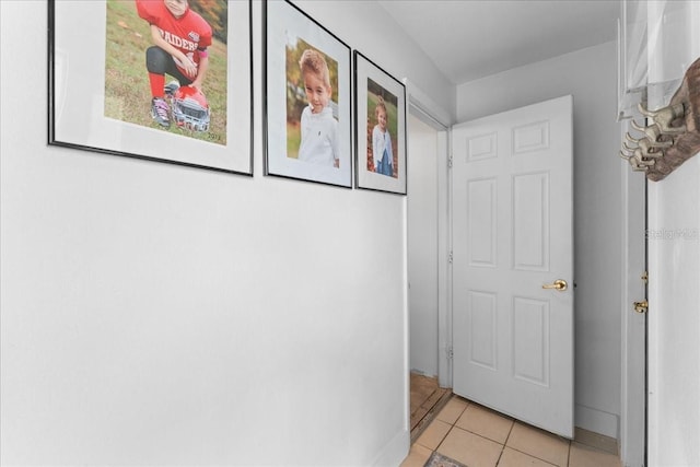 hall with light tile patterned floors