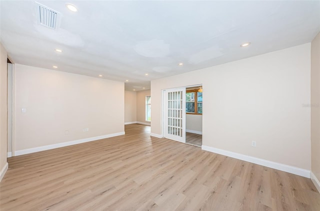 spare room featuring baseboards, light wood-style flooring, visible vents, and recessed lighting