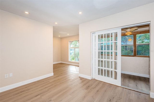 empty room featuring baseboards, wood finished floors, and recessed lighting