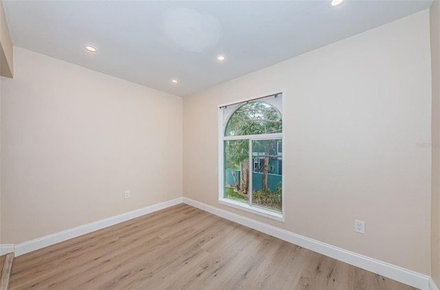 spare room with light wood-style floors, baseboards, and recessed lighting