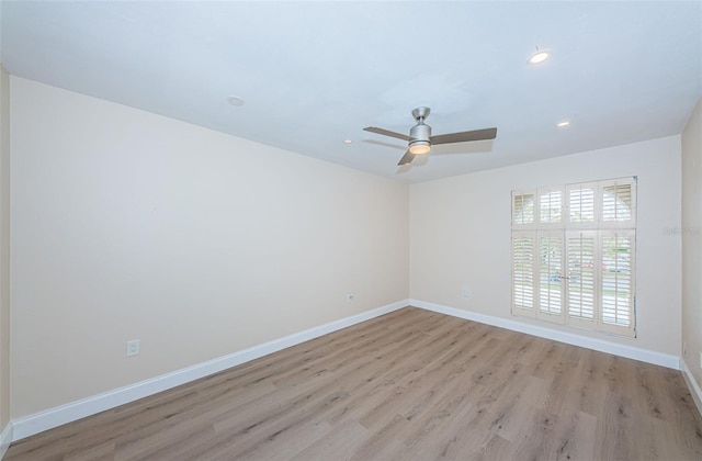 spare room featuring ceiling fan, recessed lighting, light wood-style flooring, and baseboards