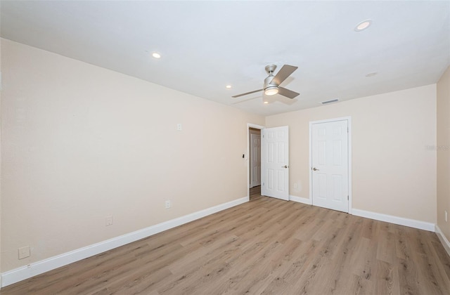 interior space featuring recessed lighting, visible vents, a ceiling fan, light wood-type flooring, and baseboards