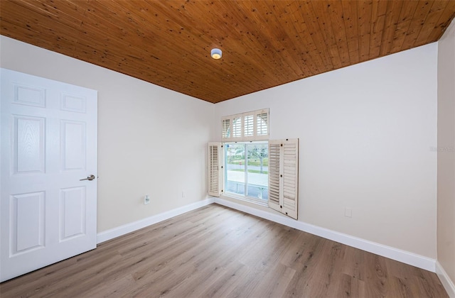 spare room featuring wood ceiling, vaulted ceiling, baseboards, and wood finished floors