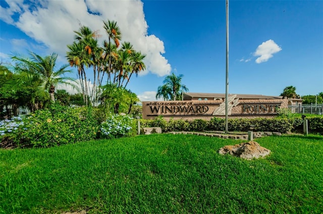 community sign featuring a yard