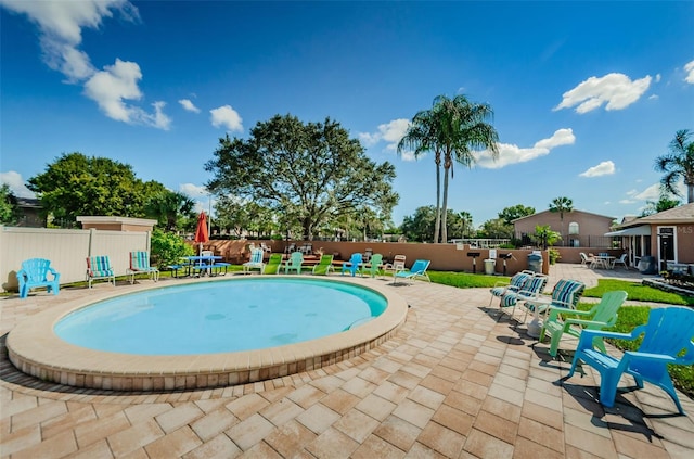 view of swimming pool featuring a fenced backyard and a patio