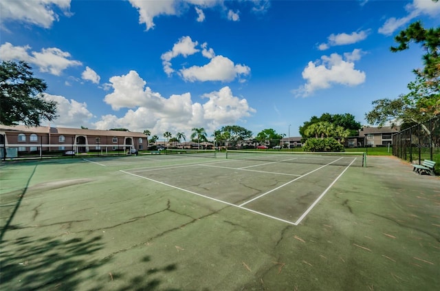 view of sport court featuring fence