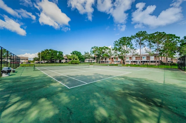 view of tennis court with fence