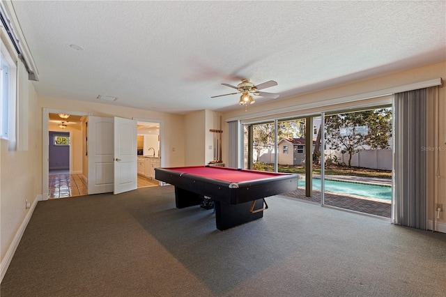 game room with pool table, a ceiling fan, carpet flooring, a textured ceiling, and baseboards