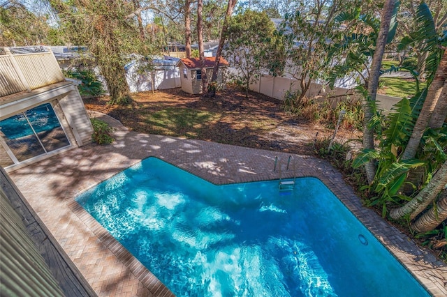 view of swimming pool featuring a patio and a fenced backyard