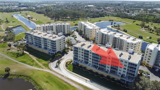 birds eye view of property featuring view of golf course and a water view