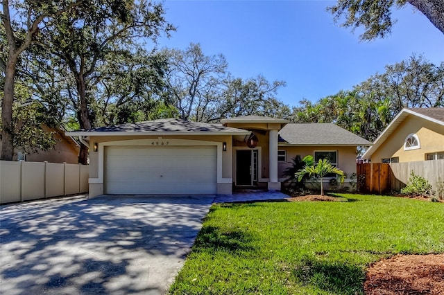 single story home with stucco siding, a front lawn, fence, concrete driveway, and a garage