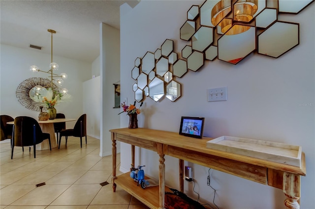 interior space with visible vents, baseboards, and a chandelier