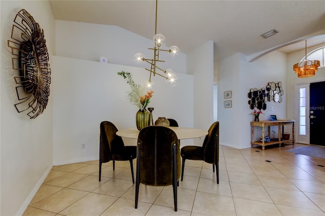 dining area featuring light tile patterned floors, visible vents, arched walkways, and vaulted ceiling