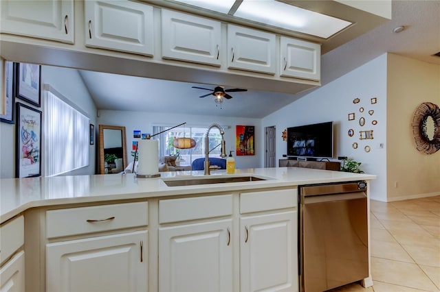 kitchen with light tile patterned flooring, ceiling fan, a sink, stainless steel dishwasher, and open floor plan