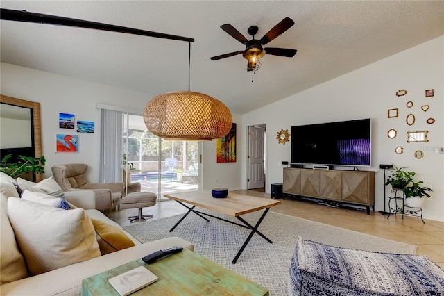 tiled living room featuring a ceiling fan and vaulted ceiling