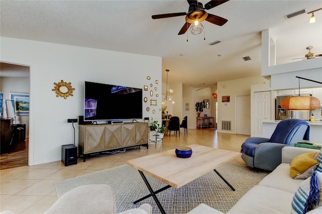 living room featuring visible vents and light tile patterned flooring