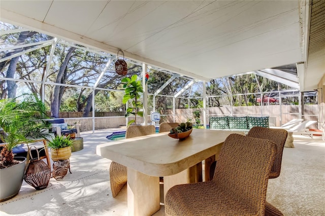 view of patio / terrace featuring glass enclosure, fence private yard, and a fenced in pool