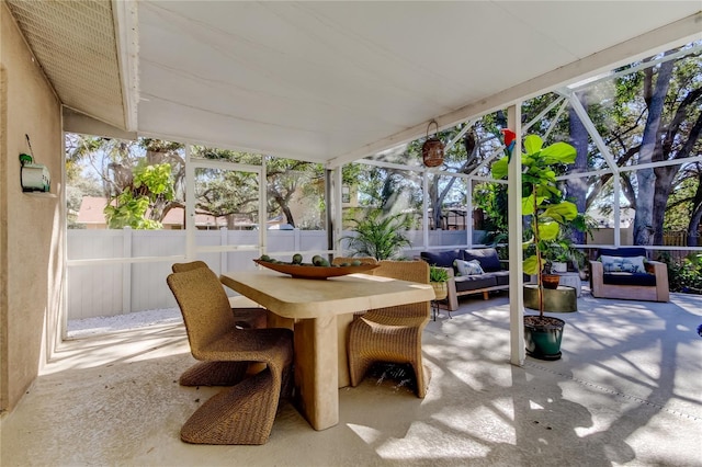 view of patio featuring a lanai, outdoor dining space, an outdoor living space, and a fenced backyard