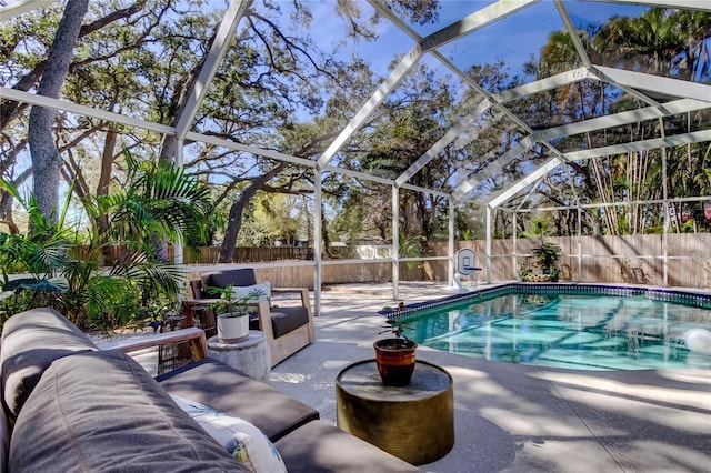 view of pool with a patio, a fenced backyard, a fenced in pool, and a lanai