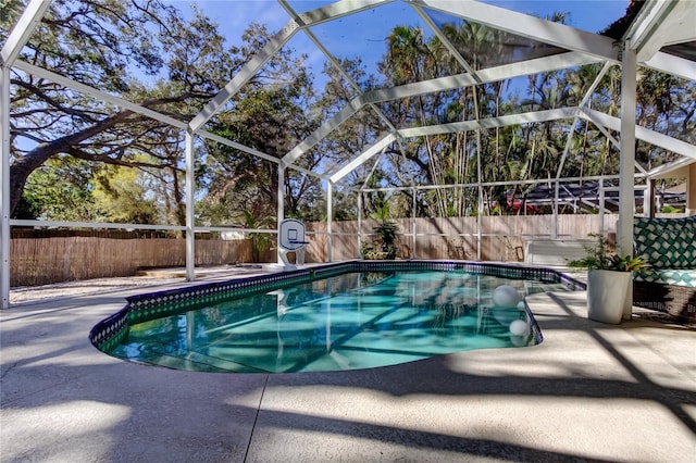 view of swimming pool with a lanai, a fenced in pool, a patio, and a fenced backyard