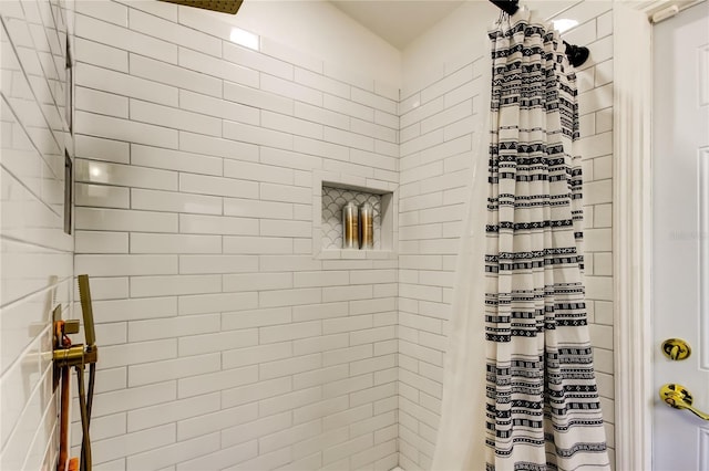 full bathroom with tiled shower