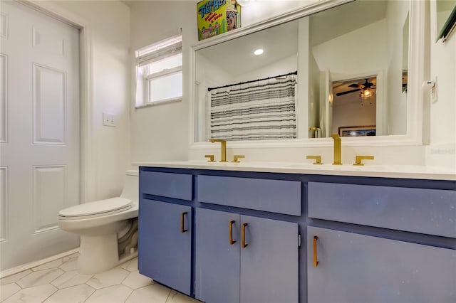 full bath with a sink, a ceiling fan, toilet, and double vanity