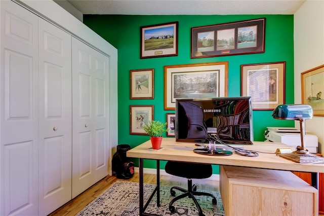 office area with wood finished floors and baseboards