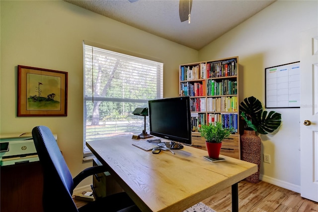 office space with baseboards, wood finished floors, ceiling fan, and vaulted ceiling