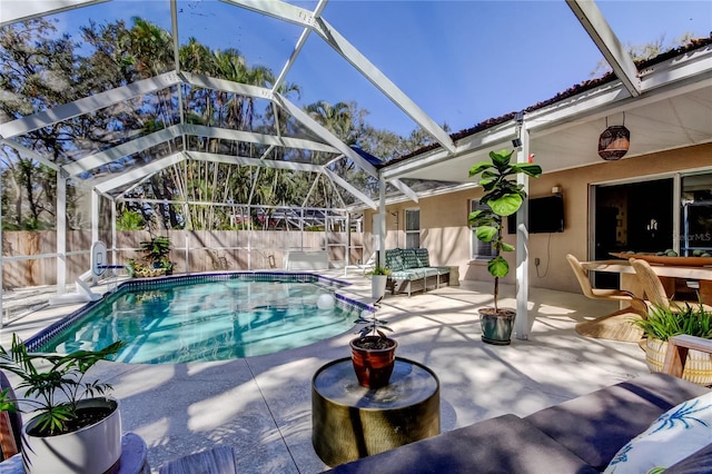 view of swimming pool featuring a lanai, a fenced in pool, a patio, and a fenced backyard